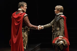 Production pic of Brutus and Cassius shaking hands